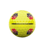 Yellow golf ball with red and black pattern on a white background