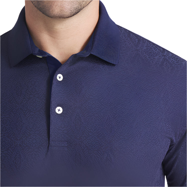 Navy blue patterned polo shirt worn by a person on a light gray background