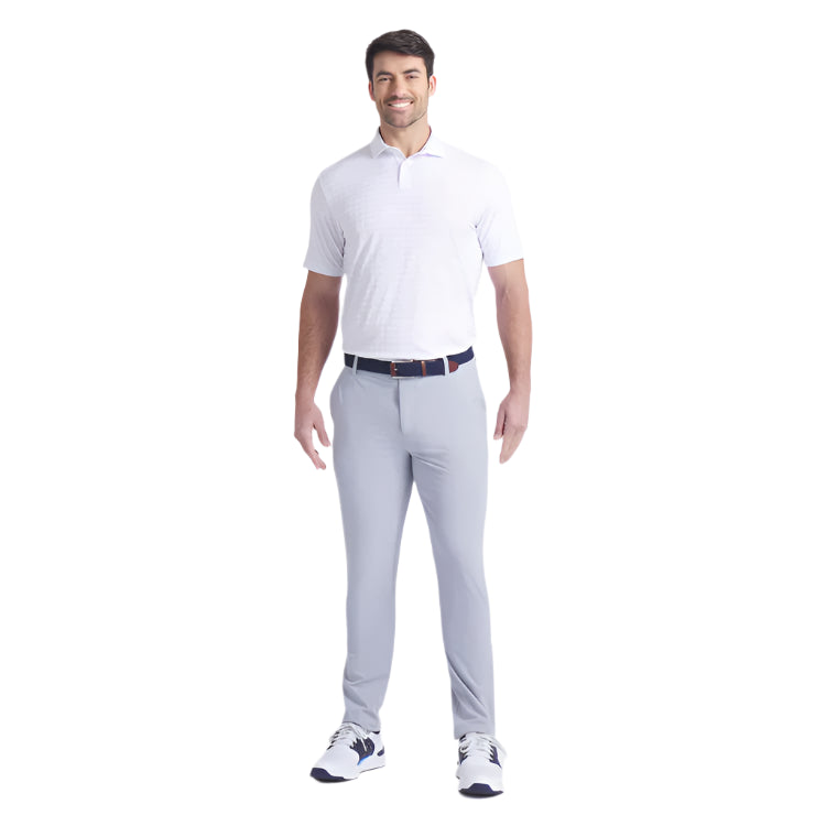 Man wearing a white polo shirt and gray pants on a white background
