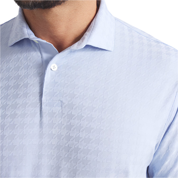Close-up of a light blue patterned shirt with a collar.