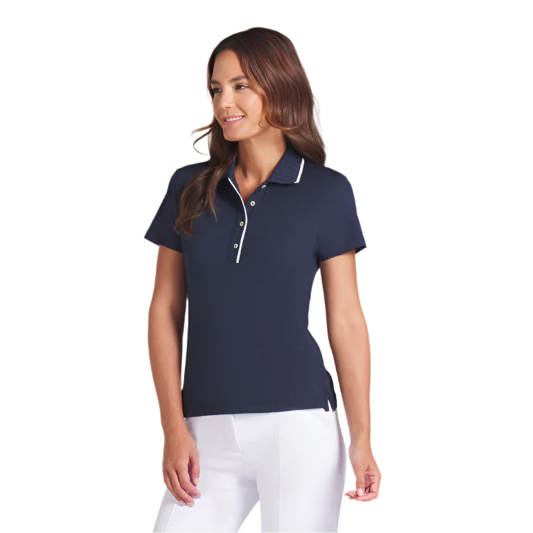 Woman wearing a navy polo shirt with white trim on a light gray background
