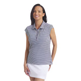 Woman wearing a striped sleeveless polo shirt and white skirt on a light gray background