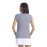 Woman wearing a striped shirt and white skirt on a plain background