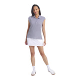 Woman wearing a striped polo shirt and white skirt on a light gray background