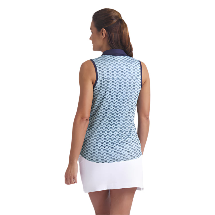 Woman wearing a patterned sleeveless top and white skirt on a light gray background