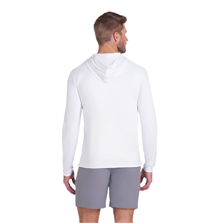 Man wearing a white long-sleeve shirt and gray shorts on a light gray background